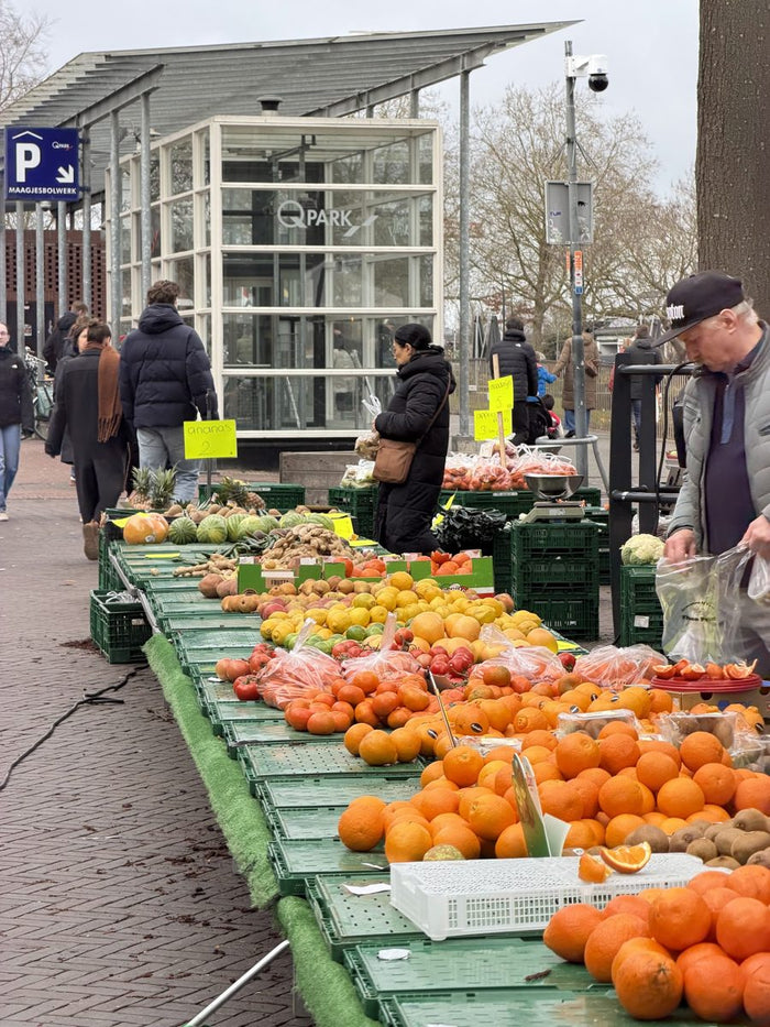 Market stalls piled with oranges