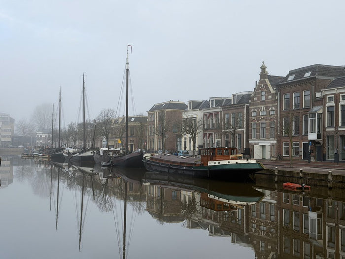 Boats on a misty canal in the early morning