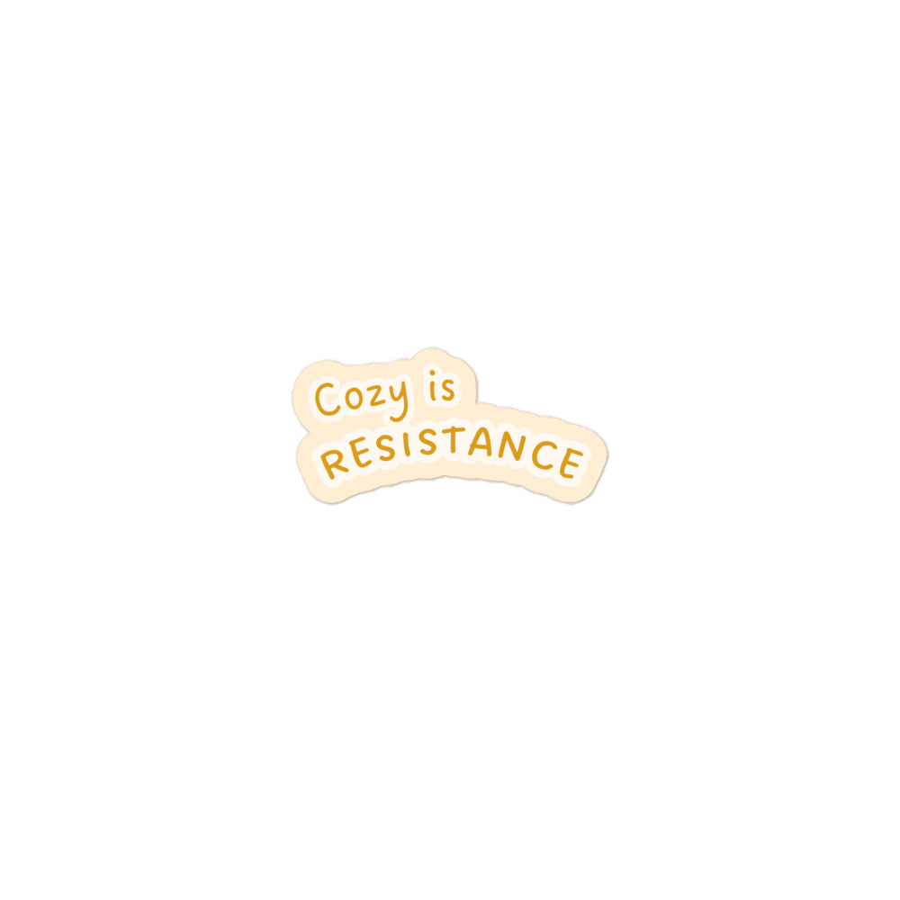 Cozy is Resistance sticker, goldenrod text on cozy cream