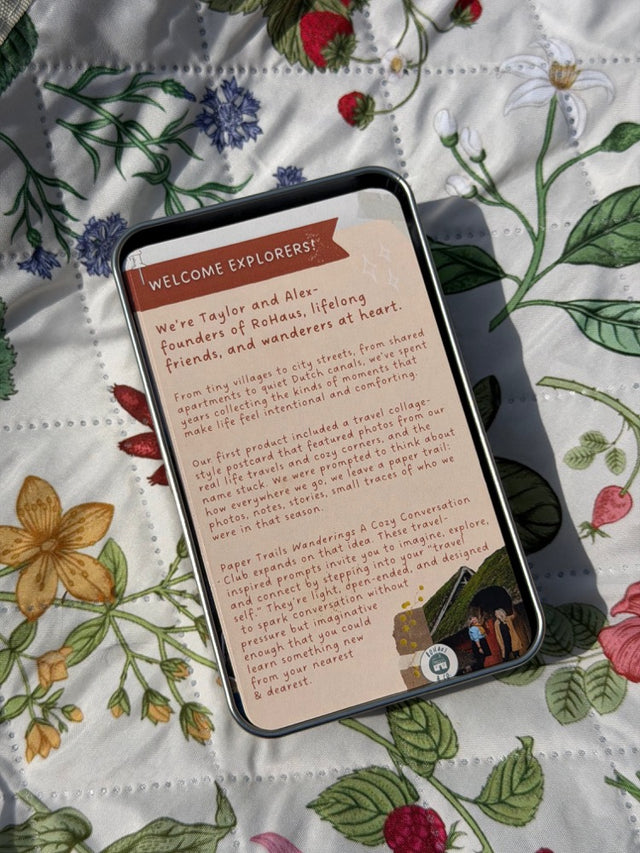 Paper Trails tin and welcome card on a floral quilt