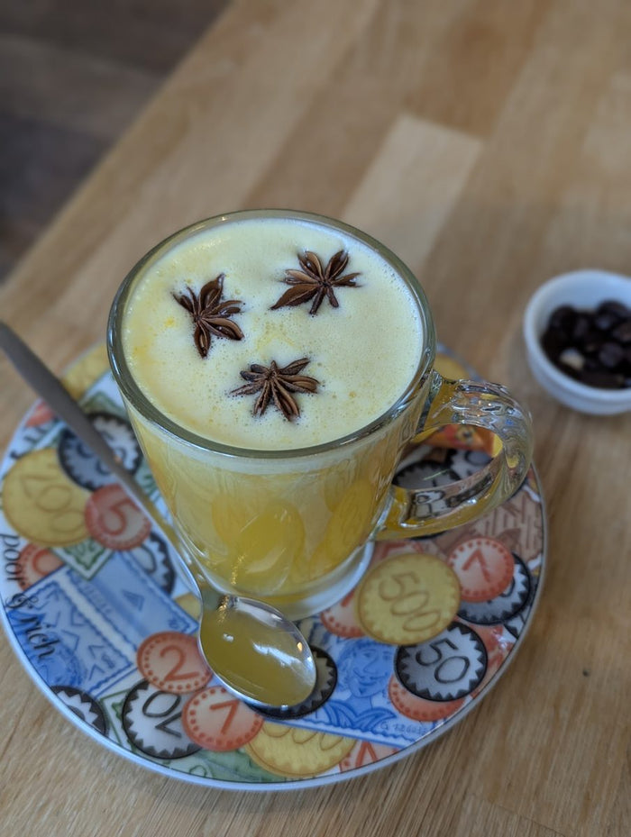 A golden milk latte topped with star anise